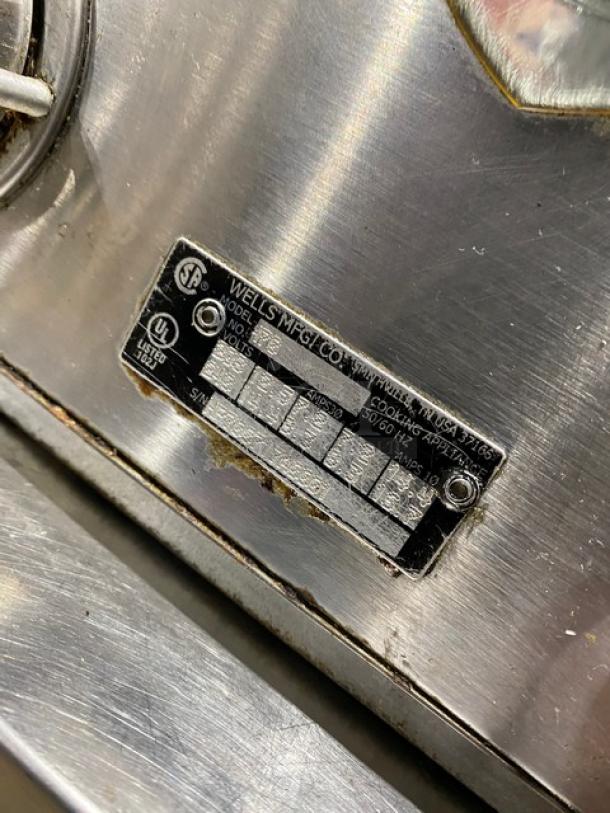 Wells Commercial Stainless Steel Electric 2-Burner Hotplate, individual controls, visible wear, model tag displayed.
