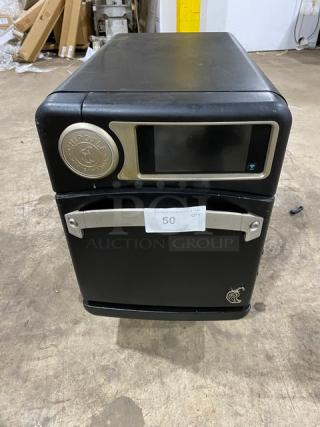 TurboChef NGO 2021 Chipotle Style Commercial Black Electric Ventless Rapid Cook Oven with crank bar, on legs.