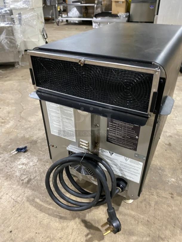 TurboChef NGO ventless rapid cook oven, 2021 model, black, electric, countertop, with crank bar and cord, on legs.