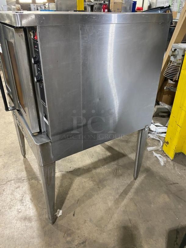 Blodgett commercial stainless steel gas convection oven, single stacked, with wired oven rack, on metal legs.
