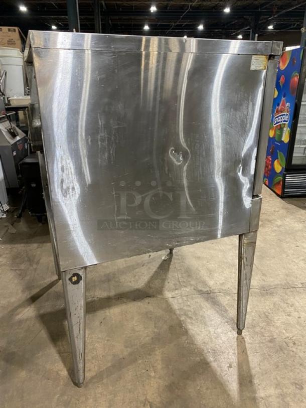 Blodgett stainless steel gas convection oven, single stacked, with wired rack, on legs. Scratches visible on surface.