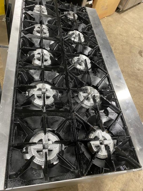 CPG Commercial stainless steel 10-burner gas range with double oven, includes wired oven rack. Like new condition.