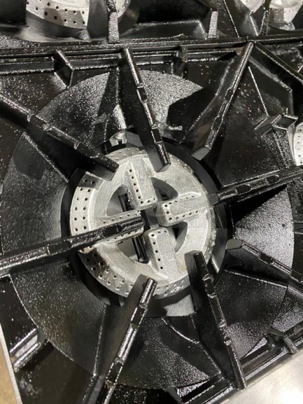 CPG stainless steel gas-powered range with 10 burners, double oven combo, and wired oven rack; close-up of burner detail.