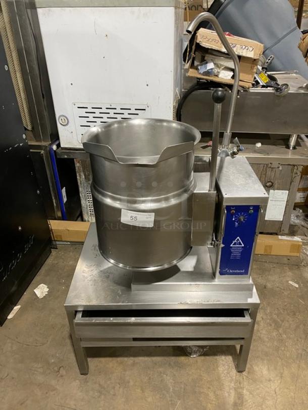 Cleveland Range stainless steel steam jacketed tilting kettle with swing spout faucet, on single drawer equipment stand.