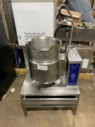 Cleveland Range stainless steel steam jacketed tilting kettle with swing spout faucet, on single drawer equipment stand.