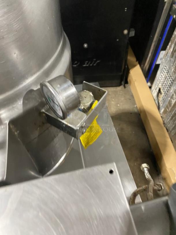 Cleveland Range stainless steel steam jacketed tilting kettle with swing spout faucet and equipment stand, gauge visible.