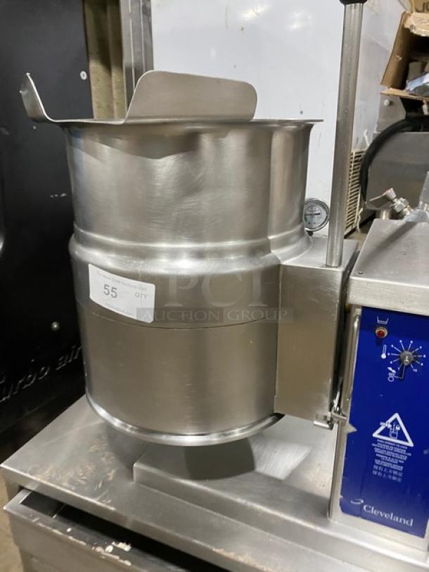 Cleveland Range commercial stainless steel steam jacketed tilting kettle with swing spout faucet and single drawer stand.