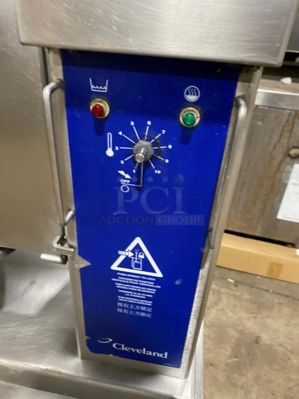 Cleveland Range stainless steel steam jacketed tilting kettle with swing spout faucet, control panel shown, on equipment stand.