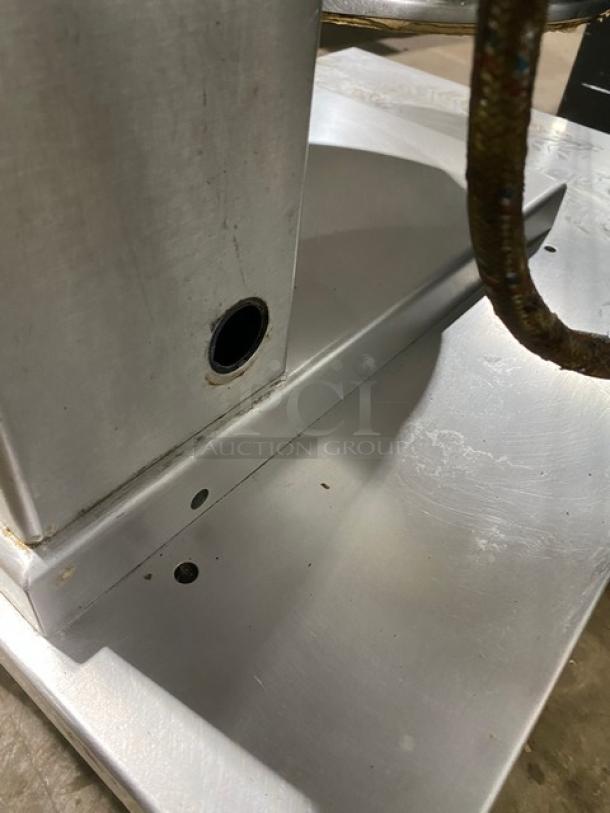 Cleveland Range commercial stainless steel steam jacketed tilting kettle with swing spout faucet and single drawer equipment stand.