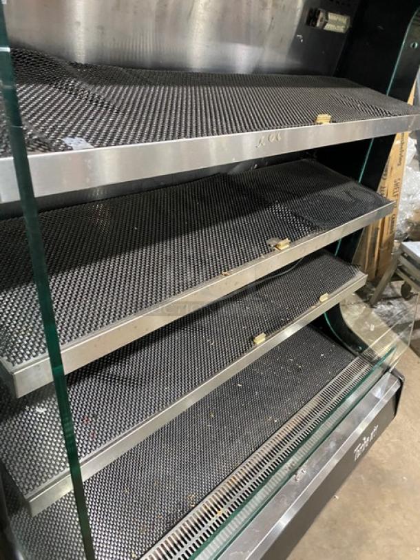 Turbo Air TOM-40M(B) black refrigerated merchandiser with stainless steel interior, multi-tier, model and serial number visible.