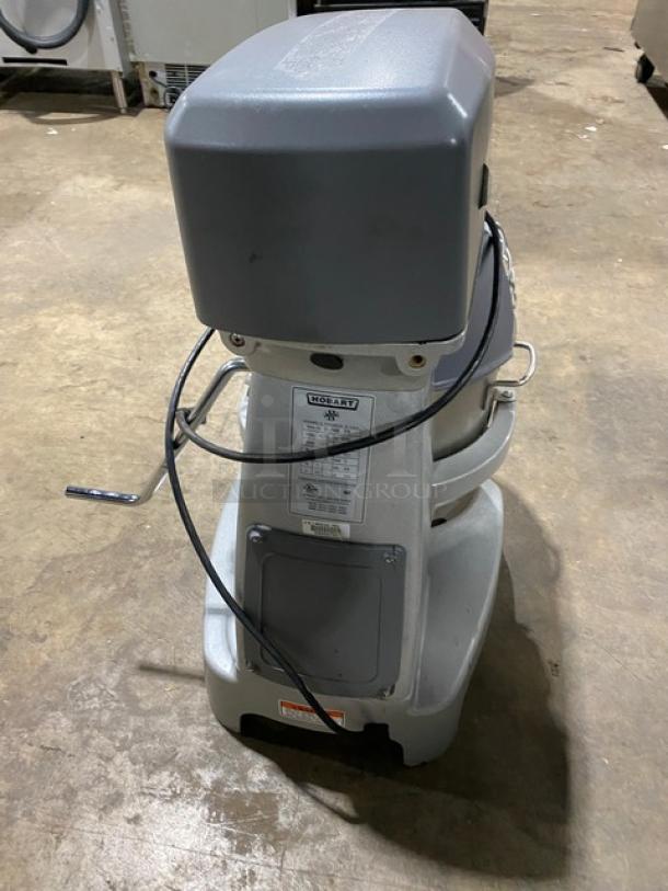 Hobart Legacy Series HL200-1STD 20 Qt. commercial planetary mixer with stainless steel bowl guard, on legs.