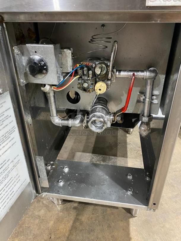 Pantin commercial stainless steel gas fryer with back splash, on legs. Visible interior piping and controls, used condition.