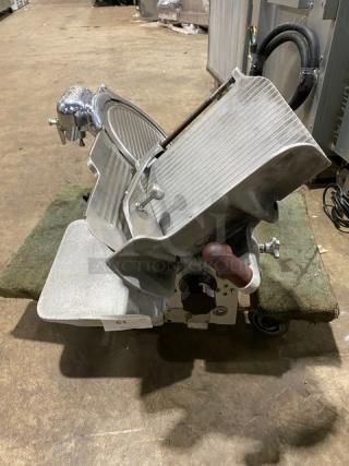 Globe Model 660 electric deli meat slicer, countertop design, used condition, serial number 674425, features adjustable legs.