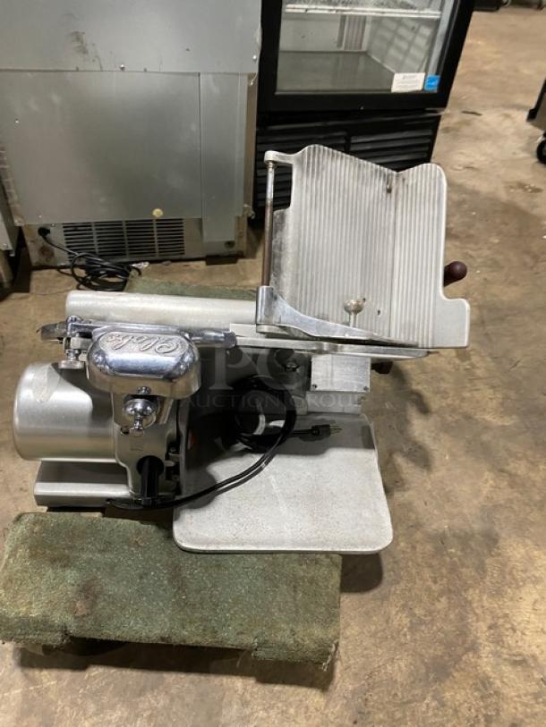 Globe Model 660 electric deli meat slicer, serial 674425, on legs, in working condition.