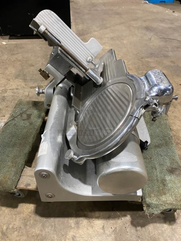 Globe Model 660 electric deli meat slicer on legs, serial number 674425, used condition, operational when last used.