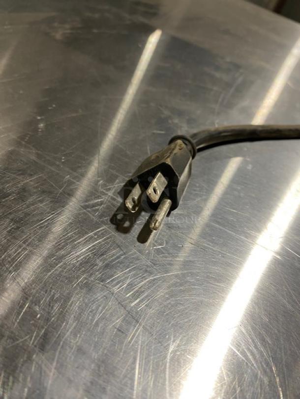 Power cord for Leader LB48SC stainless steel worktop refrigerator. 115V plug on metal surface. Item SN: AB05C2226.