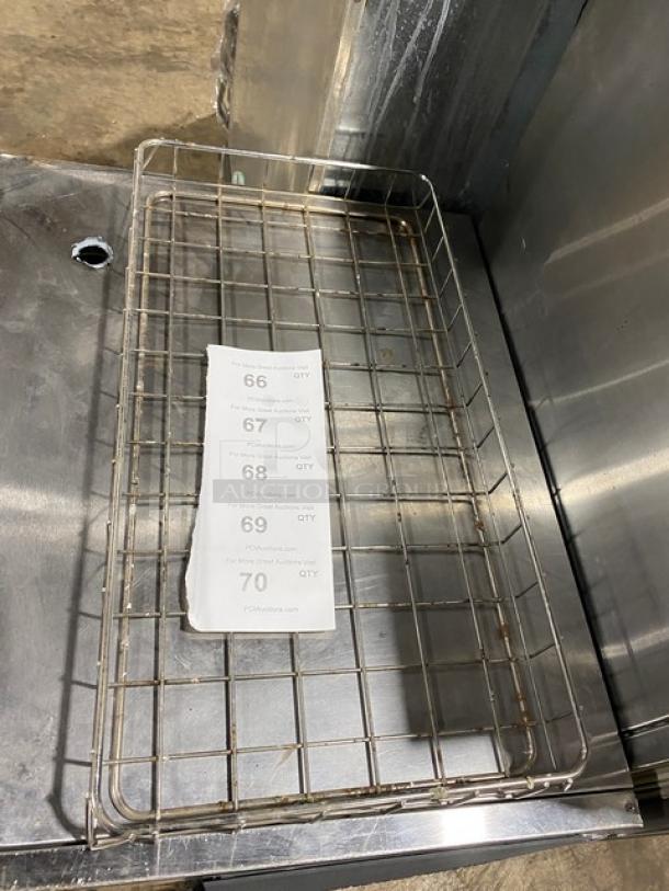 Chrome-plated full-size bagel/pastry wired rack, used condition, grid design, auction tags displayed on surface.