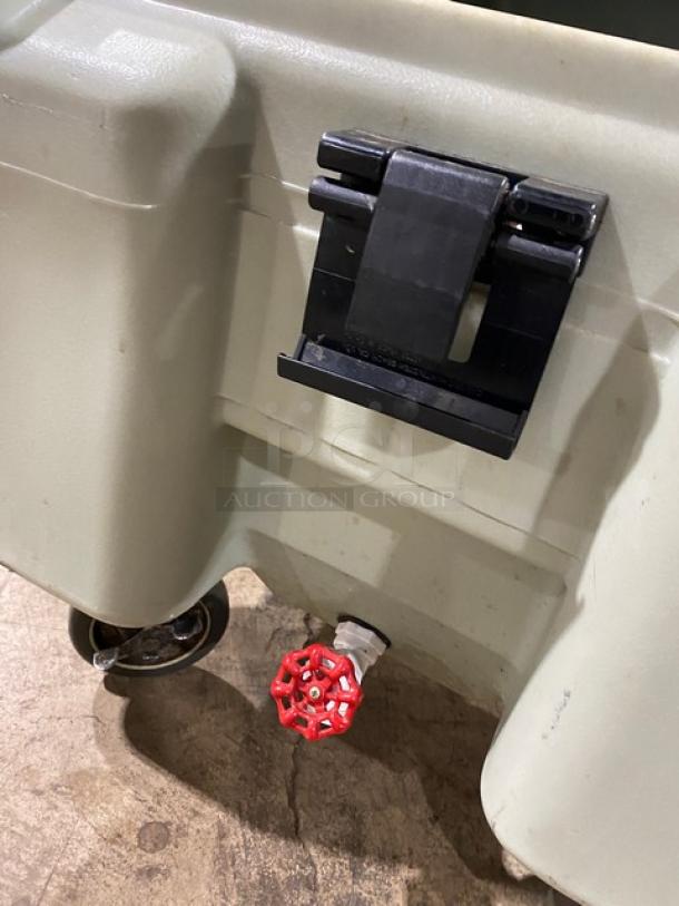 Cambro commercial insulated ice bin with drain valve, sturdy latch, and caster wheel. Good condition, ideal for food service.