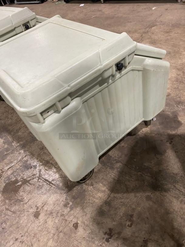 Cambro commercial insulated ice bin with lid, sturdy design, on wheels. Used condition, ideal for catering or events.