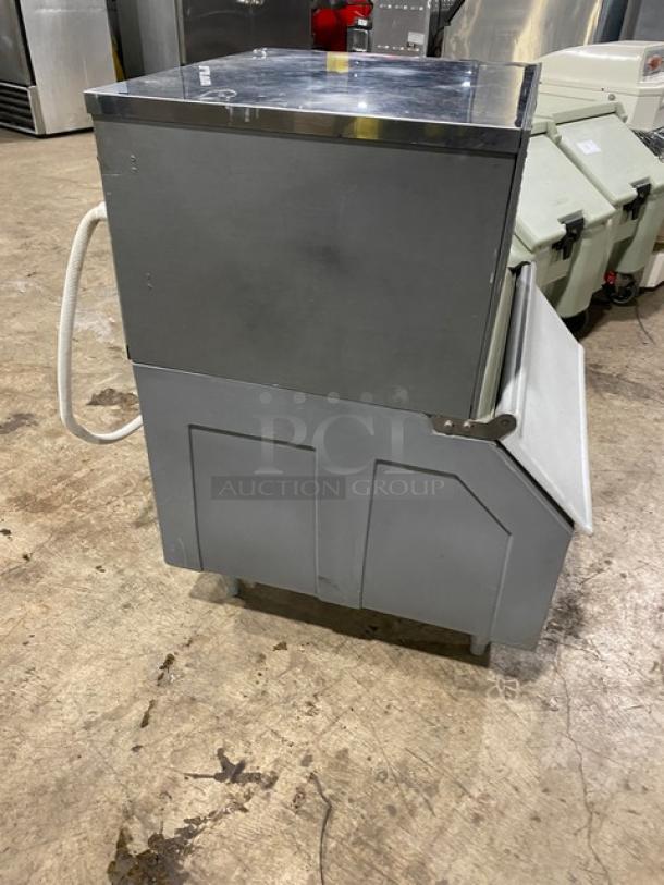 Hoshizaki KM-250BWE commercial ice maker/bin, stainless steel, air-cooled, 115-120V, on legs, visible hose, good condition.