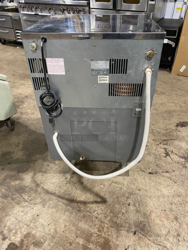 Hoshizaki KM-250BWE stainless steel ice machine, serial J02136D, air-cooled, 115-120V, 1 phase, on legs, back view with hoses.
