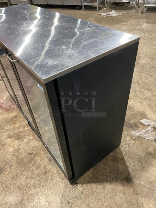 Alamo BBT350 black glass 3-door undercounter barback cooler, 115V, with poly coated wired rack and stainless steel worktop.