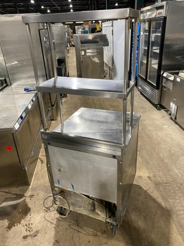 True TWT-27 stainless steel worktop refrigerator, 27", with back splash, double overhead shelf, poly-coated rack, on casters.