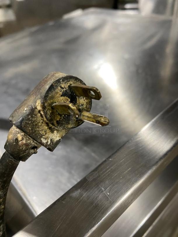 True TWT-27 stainless steel worktop refrigerator, single door. Includes backsplash, double overhead shelf, poly-coated rack, on casters.