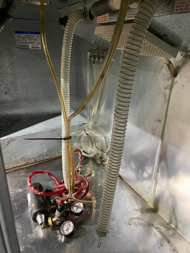 Beverage Air DD68 commercial kegerator interior, showing dual tower tap connections, hoses, and pressure gauges.