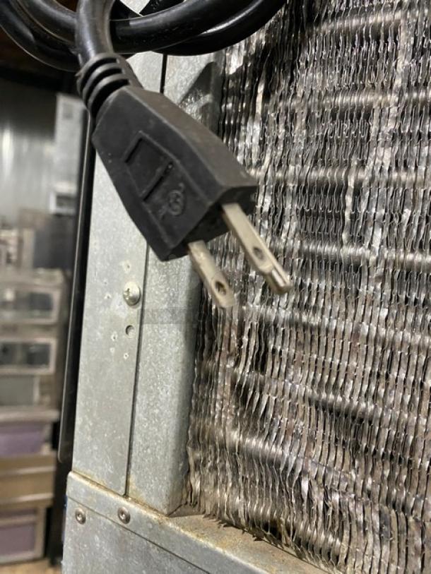 Hoshizaki KM-515MAH ice machine plug and vent detail, showing electric connector and cooling fins. Model number visible.