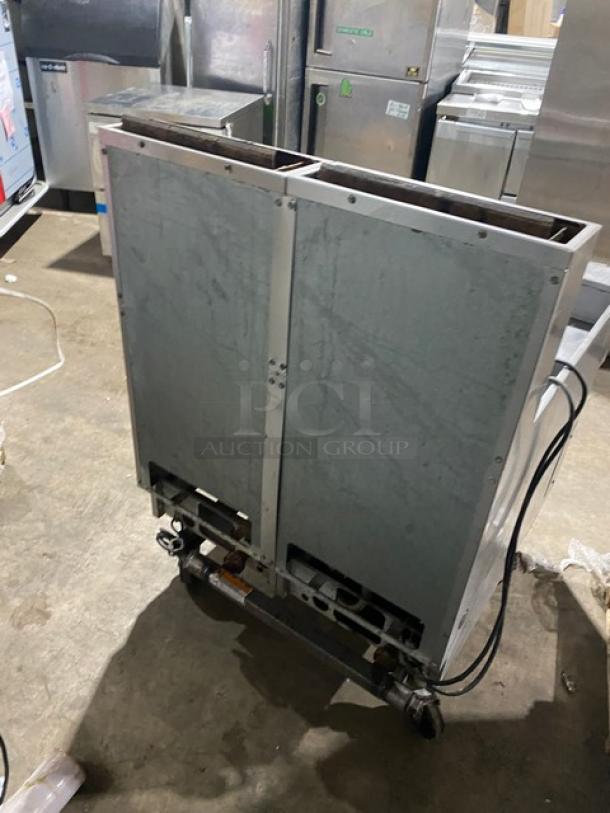 Pitco Solstice Supreme SSH55 stainless steel 2-bay 50 lb. deep fryer with filtration, backsplash, basket hanger, on casters.