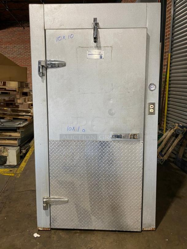Koloac 10' x 10' walk-in cooler with floor, visible compressor, blower. Metal door with diamond plate and security latch.