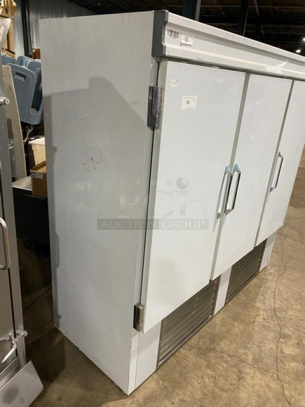 Commercial white 3-door reach-in refrigerator with poly coated wire rack, shown in good condition with handles and vents.