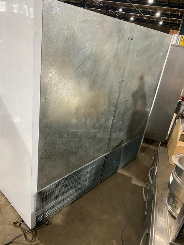 Commercial white solid 3-door reach-in refrigerator with poly coated wire rack, in used condition, ideal for storage.