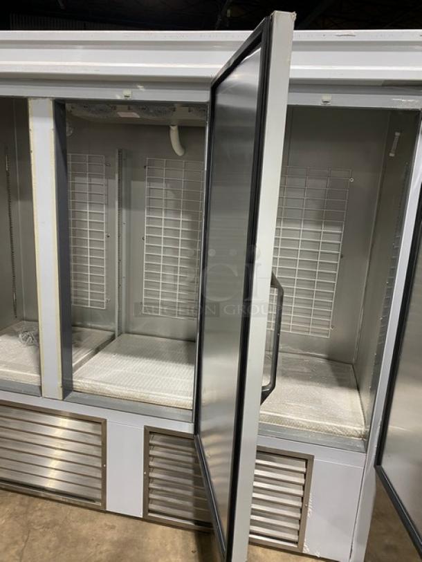 Commercial white 3-door reach-in refrigerator with poly coated wired racks, excellent condition, sturdy metal doors.