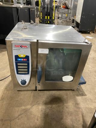 Rational electric combi oven, stainless steel, SelfCooking Center series, with built-in pan slide, on legs, shows minor wear.