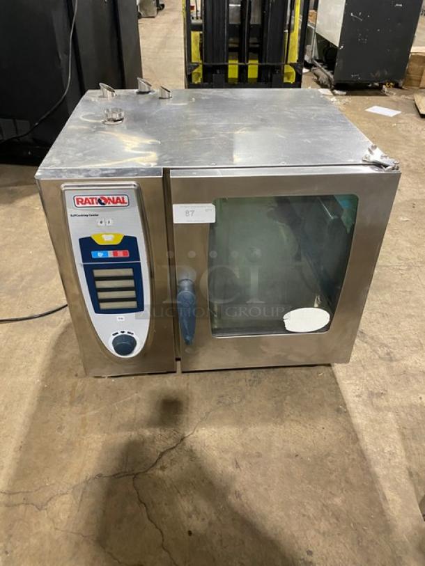 Rational SelfCooking Center commercial stainless steel combi oven with built-in pan slide, on legs. Electric powered.