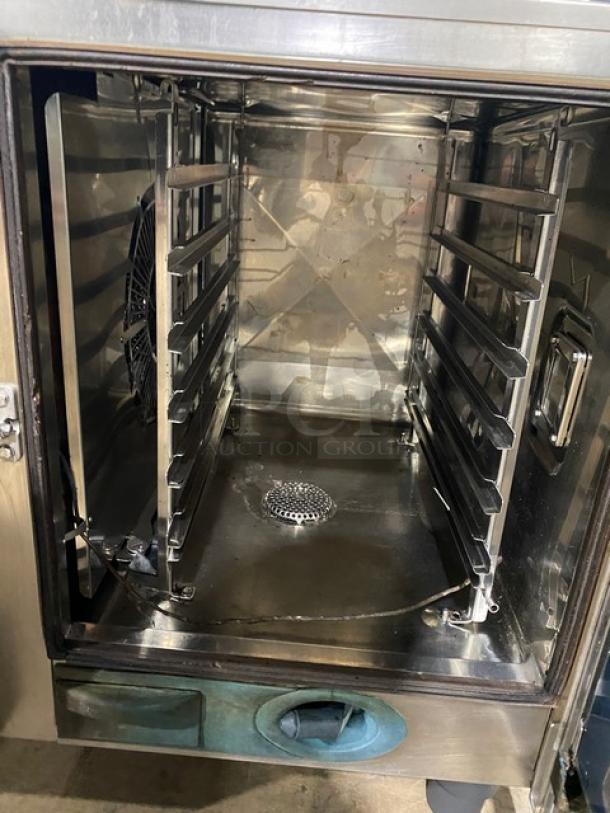 Rational SelfCooking Center commercial combi oven, stainless steel, built-in pan slide, visible fan, on legs, used condition.
