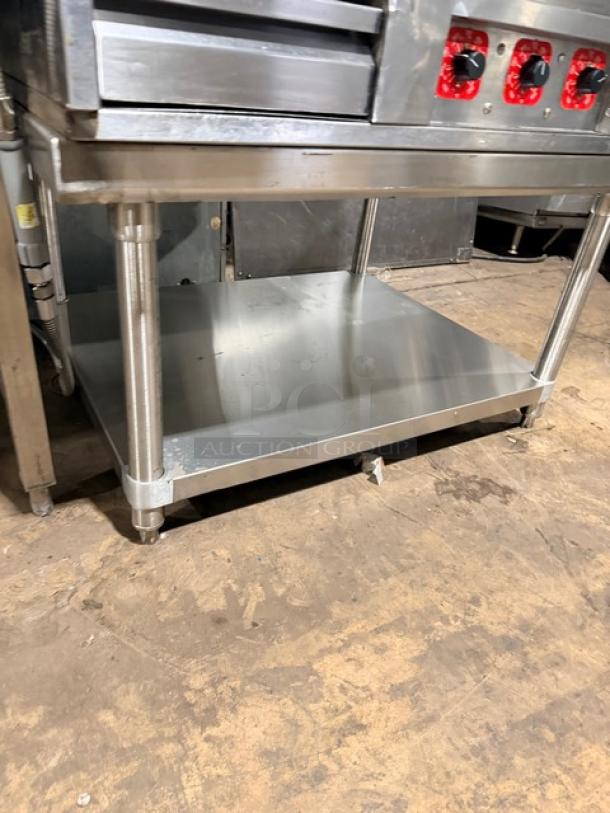 MagiKitch'n commercial heavy-duty natural gas flat griddle with shiny stainless steel stand; thermostatic controls visible.