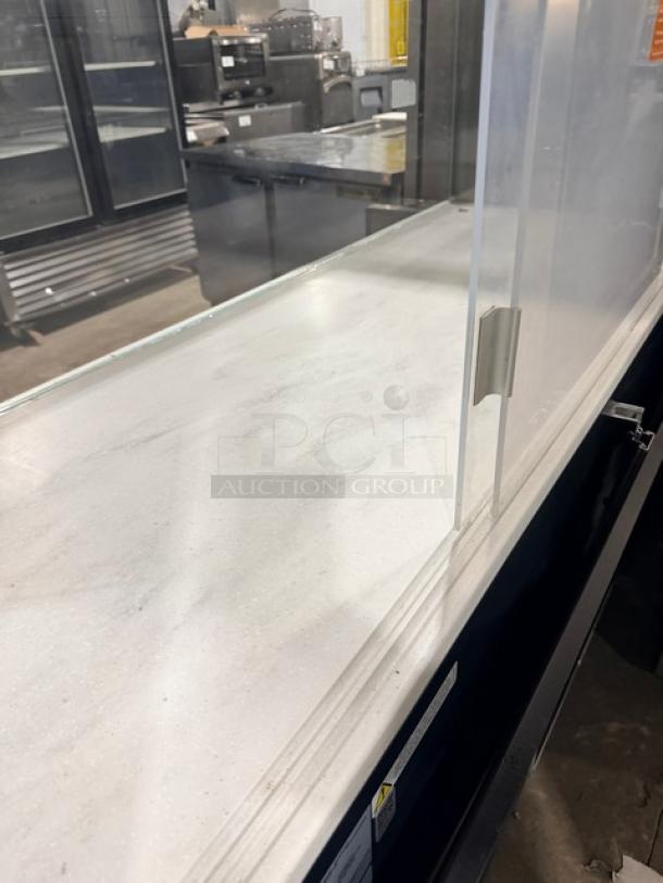 Structural Concepts refrigerated display case, model SBZ6652DR. Black, open grab-n-go style, enclosed top glass, rear sliding doors.