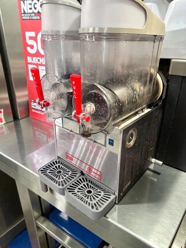Ugolini NHT2 double bowl slush machine, superior condition, NSF & UL listed, fully operational, stainless steel, red pull handles.