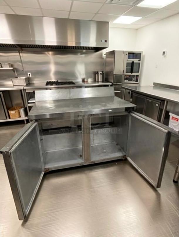 Continental two-door stainless steel undercounter worktop refrigerator in prime condition, with open doors in a commercial kitchen.
