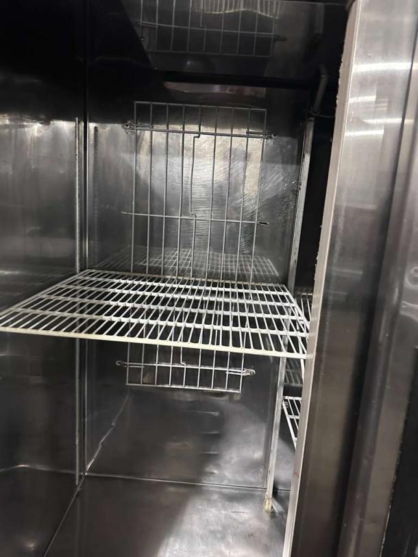 Stainless steel commercial double door reach-in refrigerator, interior view, wire shelving, UL & NSF listed, excellent condition.