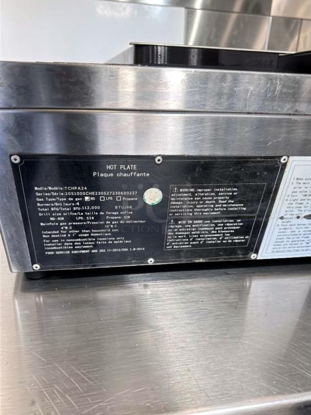Crestware TCHPA24 commercial gas hot plate, stainless steel, 4 burner, model TCHPA24, fully operational, label details visible.
