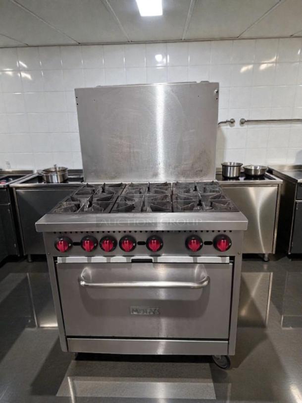 Montague 6-burner commercial gas range with oven, natural gas, NSF listed, tested, operational, stainless steel finish.