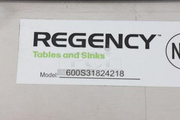Regency stainless steel three-compartment sink, model 600S31824218, minor scratches, scuffing, and dents, with label.