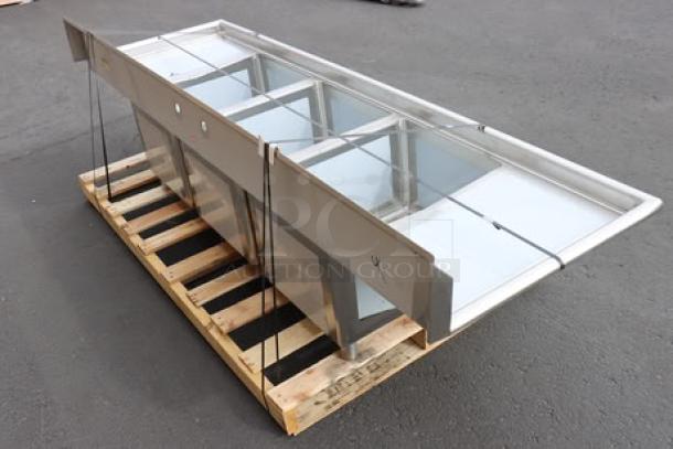 Regency 94" stainless steel three-compartment commercial sink, model 600S31824218, with two drainboards. Minor scratches and dents.