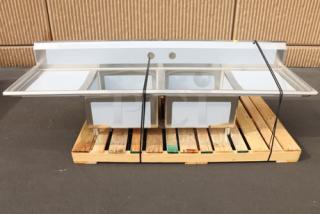 Regency S2C232312-24L&R 96" stainless steel two-compartment sink, 23"x23"x12" bowls, with 2 drainboards, new, minor scuffs.