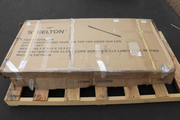 Brand new Steelton ES-3060 stainless steel equipment stand in packaging, with 30" x 60" surface, undershelf, and galvanized legs.