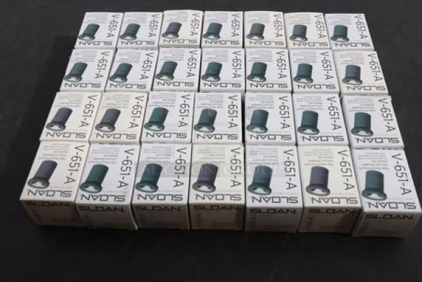 28 unopened Sloan V-651-A Vacuum Breaker Repair Kits, brand new in original packaging, displayed in rows.